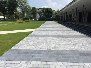 HSN Bluestone Tumbled stone paving driveway beside landscaped garden and modern building