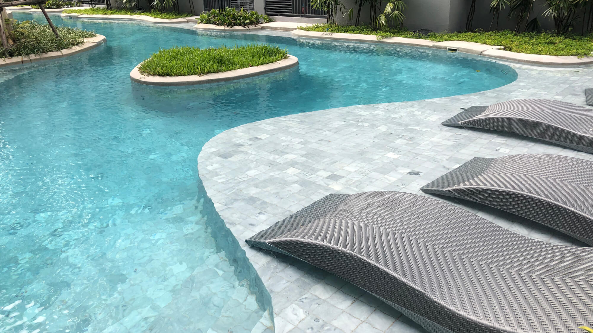 Sanded Tribeca limestone used on a swimming pool, side view with chairs